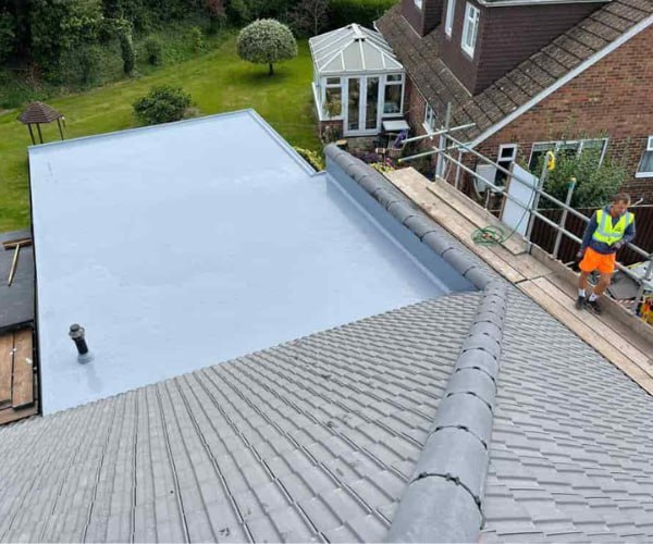 This is a photo of a newly installed hip roof, with a combined liquid covered flat roof. Work carried out by NRS Roofing Thrapston