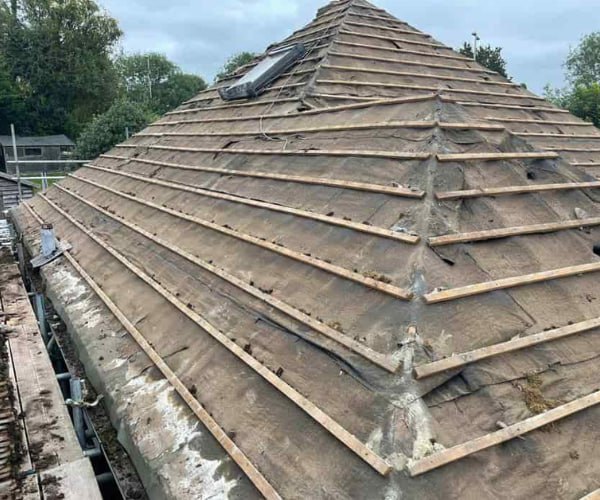 This is a photo of a hip roof that has been stripped back to the battens, and is awaiting a new roof covering to be installed. Works carried out by NRS Roofing Thrapston